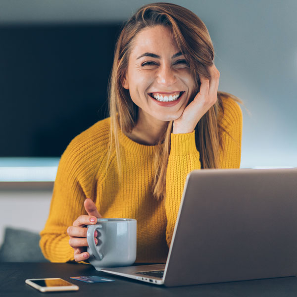 young woman smiling with cup of coffee