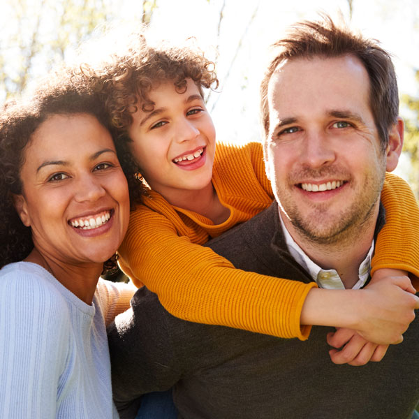 smiling family of three